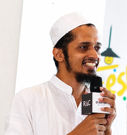 Portrait of Haris I M speaking into a microphone
